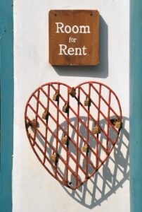 closeup photo of room for rent sign